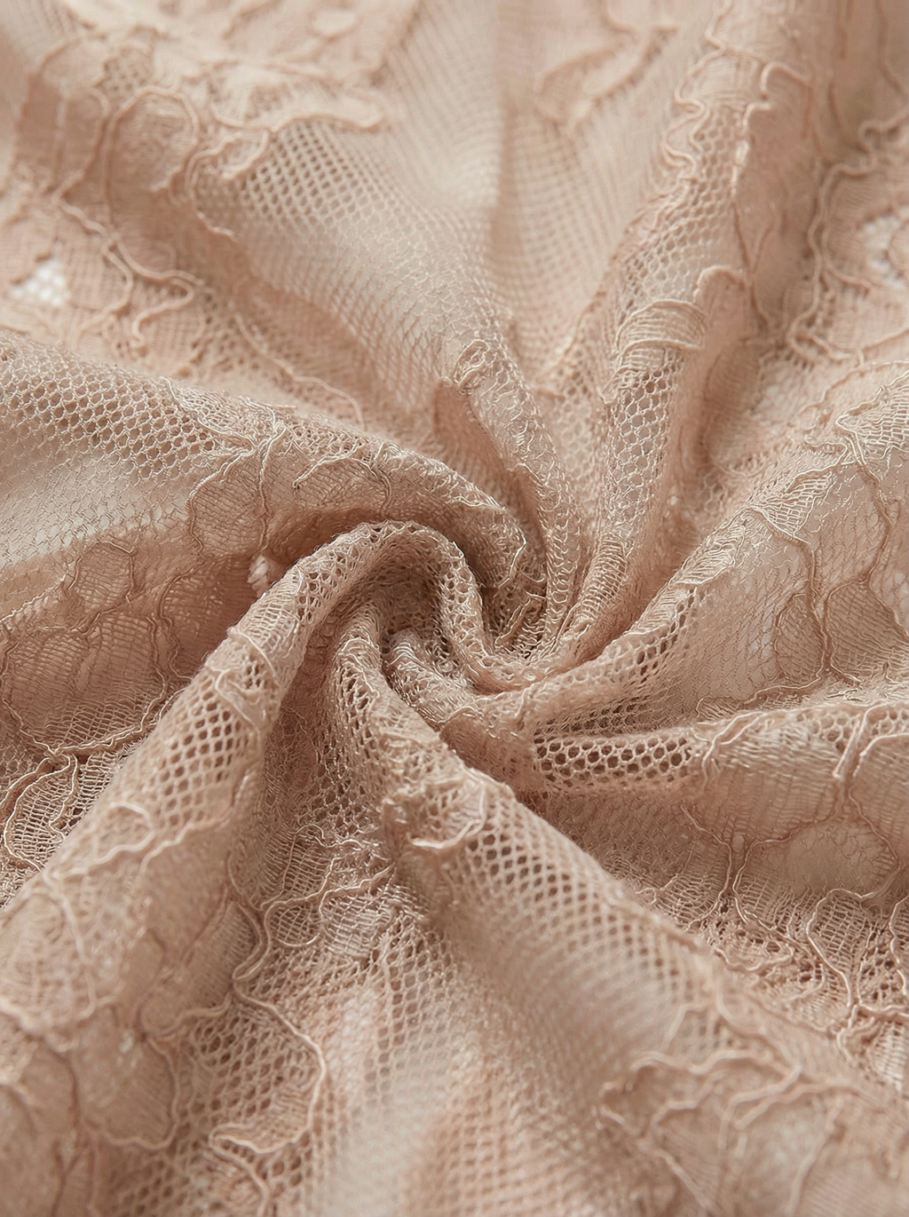Close-up texture of delicate nude floral lace fabric. Sheer beige mesh material featuring intricate floral embroidery, commonly used in luxury lingerie, romantic intimates, and bridal wear.