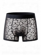 Flat lay front view of the ILLUSION black men's beige sheer ice silk boxer briefs, showing the transparent webbed mesh pattern and comfortable elastic waistband.
