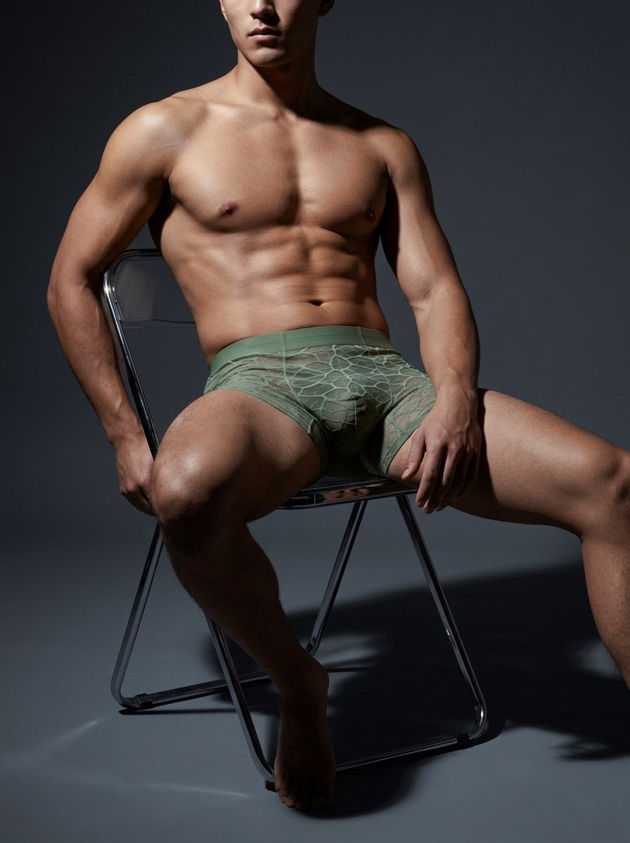 Front view of an athletic male model, wearing the Velvet Fluxe ILLUSION matcha green ultra-thin sheer boxer briefs, demonstrating a comfortable bare-sensation fit.