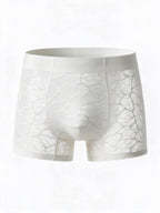 Flat lay front view of the ILLUSION white men's apricot sheer ice silk boxer briefs, showing the transparent webbed mesh pattern and comfortable elastic waistband.
