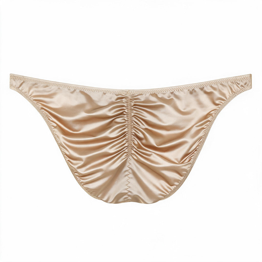 Flat lay back view of the men's champagne light luxury satin brief, detailing the ruched rear seam for natural sculpting and smooth, cooling high-stretch fabric.