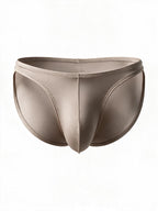Flat lay of the men's silver ice silk satin brief, displaying the creative stretch stitching, sensual thin waist straps, and contoured breathable front pouch.