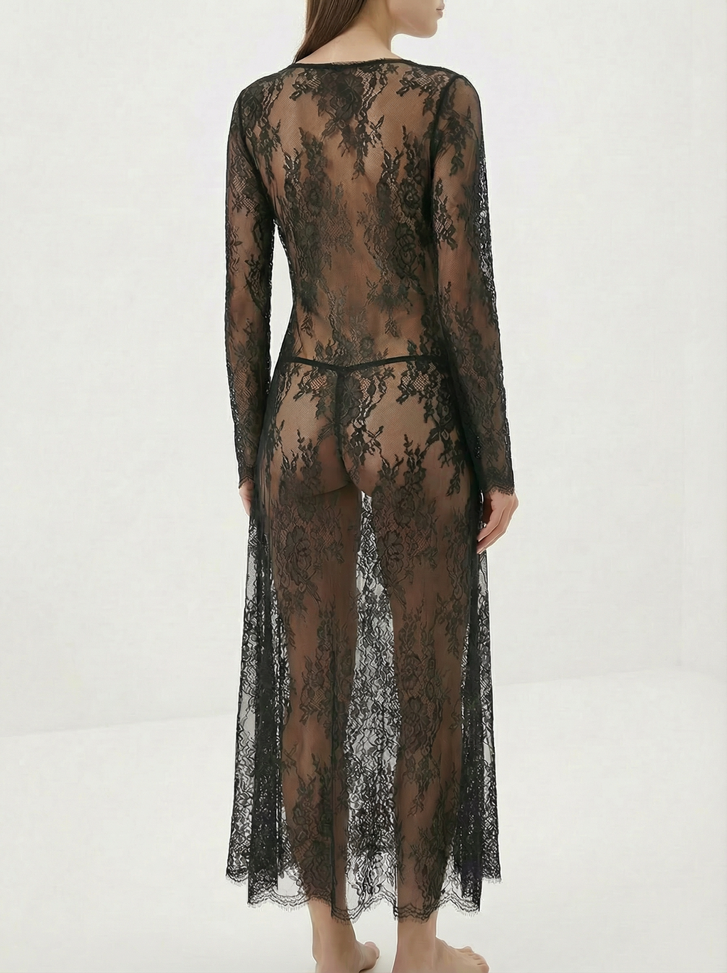 Velvet Fluxe Noir sheer floral lace maxi gown with leopard print silk lining and long sleeves, avant-garde evening wear.
