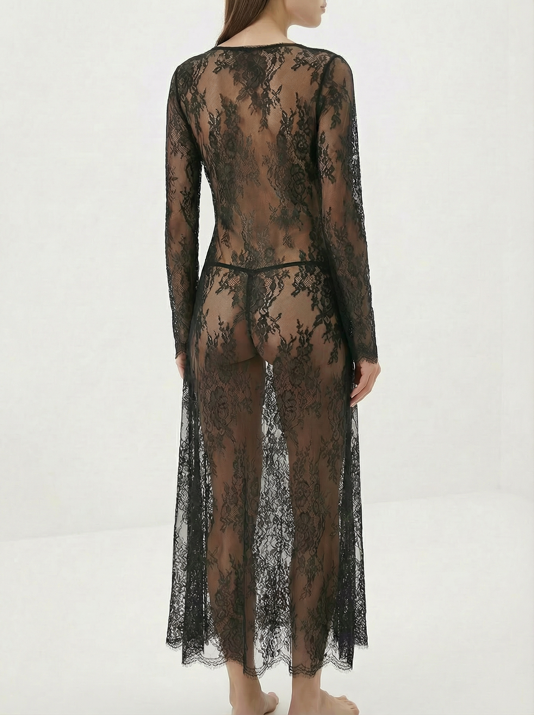 Velvet Fluxe Noir sheer floral lace maxi gown with leopard print silk lining and long sleeves, avant-garde evening wear.
