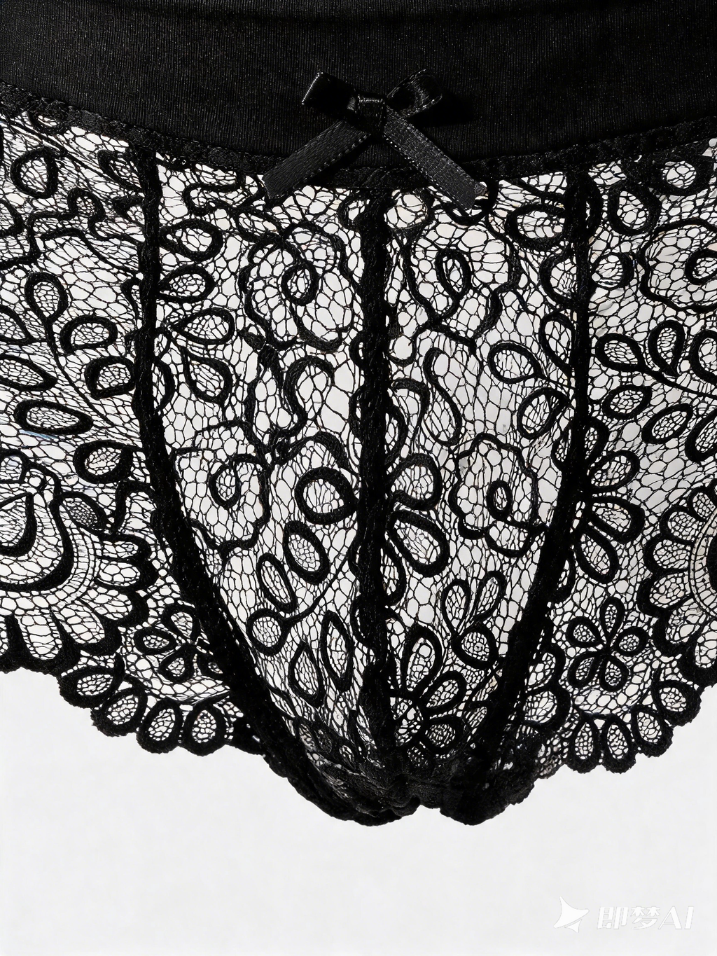 Close up of Velvet Fluxe NOCTURNE French men's sheer black lace boxer briefs. Product view showing the intricate floral lace pattern, solid black elastic waistband for support, and a subtle center bow detail.
