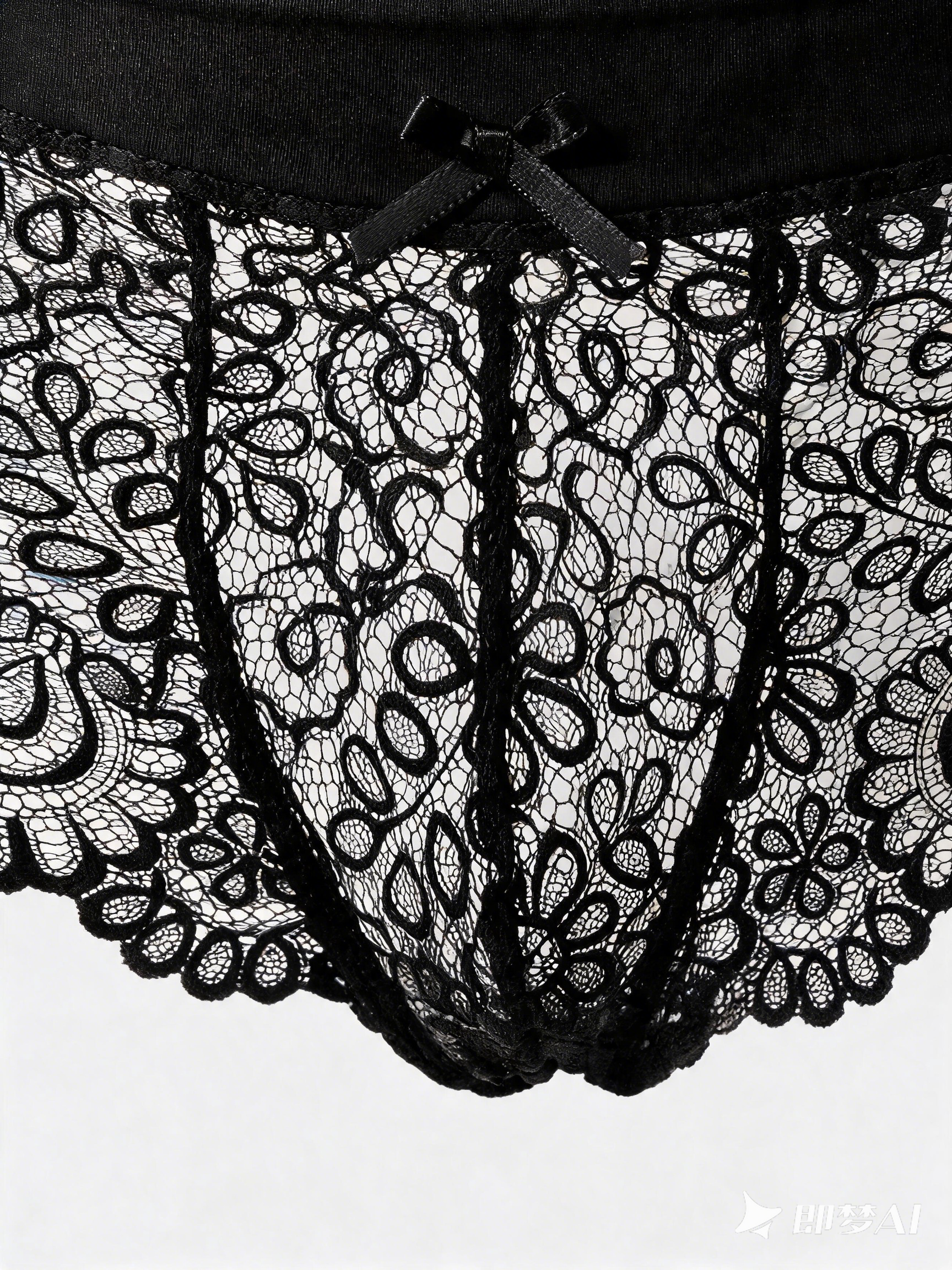 Close up of Velvet Fluxe NOCTURNE French men's sheer black lace boxer briefs. Product view showing the intricate floral lace pattern, solid black elastic waistband for support, and a subtle center bow detail.