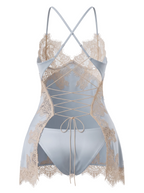 Back 3D product view of the Velvet Fluxe Céleste ice blue satin chemise. Showcasing the intricate corset-style lace-up open back, sheer champagne eyelash lace trim, delicate cross straps, and a dramatic split skirt over a matching satin panty against a clean background.