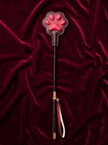Velvet Fluxe FELINA thermo-reactive cat paw paddle. Full front view displaying the 3D heat-sensitive paw pads, braided stem, and gold hardware against a luxury dark red velvet background.