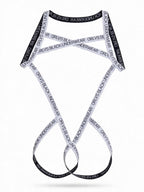 Flat lay product shot of the white men's elastic harness with black lettering, highlighting the durable webbing material and criss-cross construction on a white background.